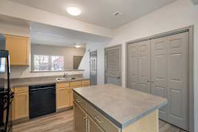 A kitchen with a sink and a counter top.
