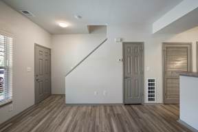 A room with a staircase and two doors.