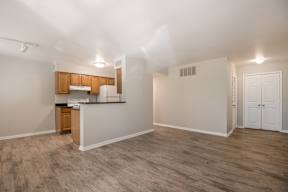 A kitchen area with wooden cabinets and a countertop.