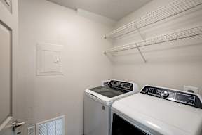A small laundry room with a washer and dryer.