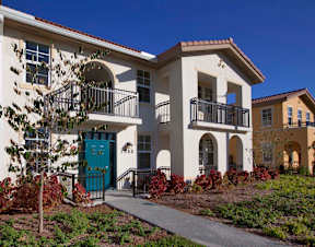 A white house with a blue door and windows.