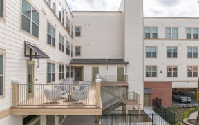 the outlook of an apartment building with a balcony and tables