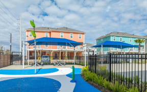 our apartments have a playground with a swing set and umbrellas