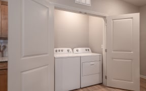 a washer and dryer in a laundry room with white doors