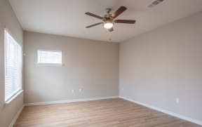 a living room with a ceiling fan and a window