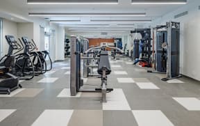 a gym with cardio equipment and weights at Perkins Square Apartments
