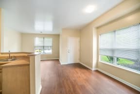 an empty kitchen and living room with a large window