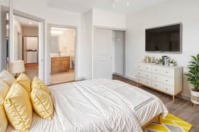 a bedroom with a bed and a tv