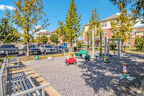 A playground with a red slide and a green slide.