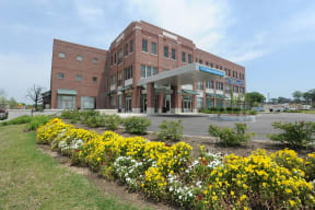 a large brick building with flowers in front of it
