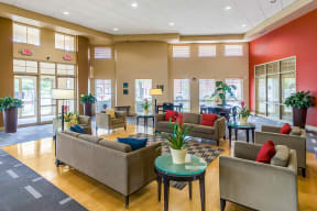 a large lobby with couches and chairs and tables at Renaissance Place at Grand Apartments & Townhomes