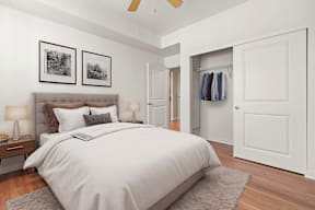A bedroom with a large bed and a ceiling fan.