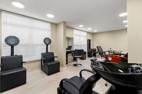 a salon with chairs in a room with windows at South City Senior in Memphis, TN