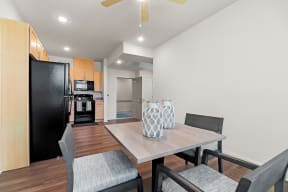 Dining Room and kitchen with light wood cabinets and black appliances at South City Senior in Memphis, TN