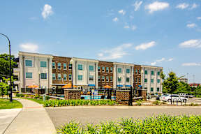 A large building with a fence in front of it.