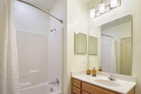 A bathroom with a white tub and sink.