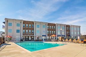 A large building with a pool in front.