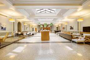 A spacious cafeteria with tables and chairs and a counter.