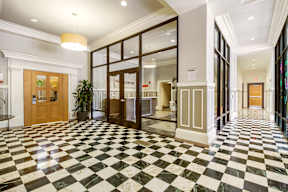A black and white checkered floor in a hallway.