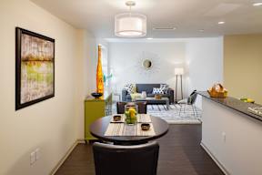 A modern dining room with a table set for two.