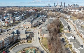 an aerial view of a neighborhood with a city in the background
