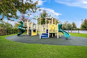 a playground with slides and other toys in a park