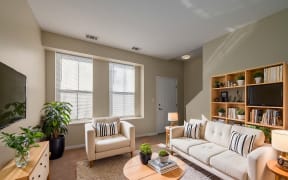 a living room with two white couches and a coffee table