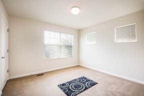 an empty room with a carpeted floor and a window