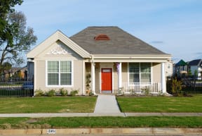 the front of a house with a red door