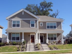 a house with a front porch on a hill
