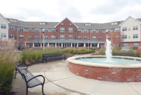 a fountain in front of an apartment building
