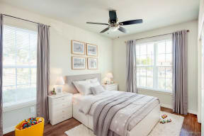 a bedroom with a bed and a ceiling fan