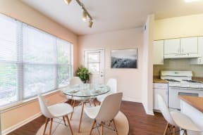 a kitchen and dining room with a table and chairs