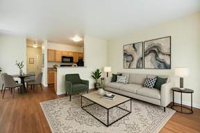 A living room with a couch, chairs, and a coffee table.