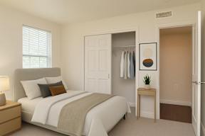 A bedroom with a bed, nightstand, and a small table with a plant on it.