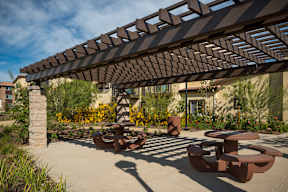 Outdoor courtyard with trellis above and picnic tables on the ground-Parque Vista, Los Angeles, CA