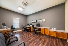a conference room with desks and chairs and computers