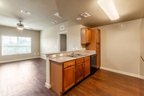 an empty kitchen with a counter top and a sink