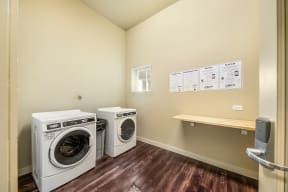 a laundry room with two washes and a dryer