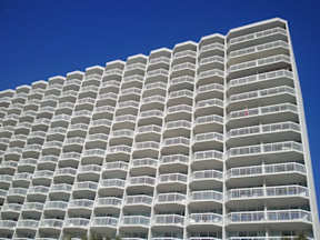 an apartment building with a blue sky above it