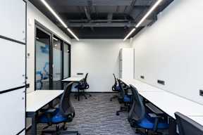 A row of chairs are lined up in a room.