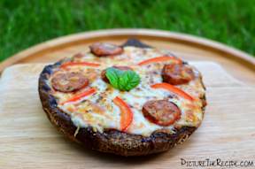 a pizza sitting on top of a wooden cutting board