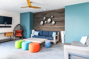 a living room with blue walls and colorful furniture