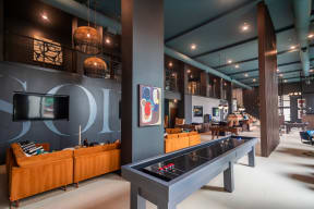 a game room with a foosball table and a television