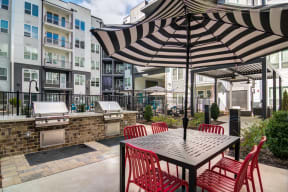 a patio with an umbrella and a table with chairs