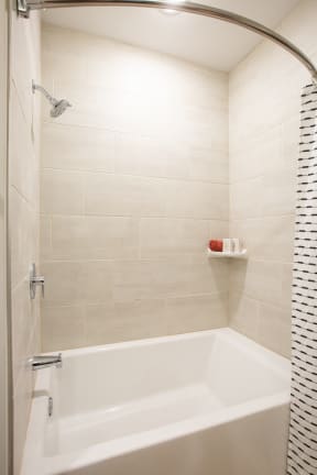 a white bath tub in a bathroom with a shower curtain