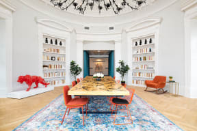 a dining room with a table and chairs and bookshelves
