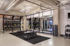 a gym with weights and equipment in a loft