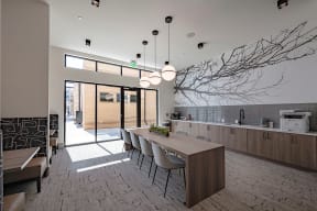 a kitchen and dining area with a tree mural on the wall