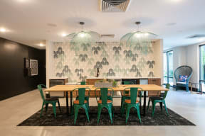 a large dining room with a wooden table and green chairs